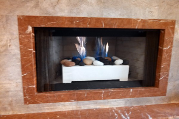 gas fireplace with river stone display